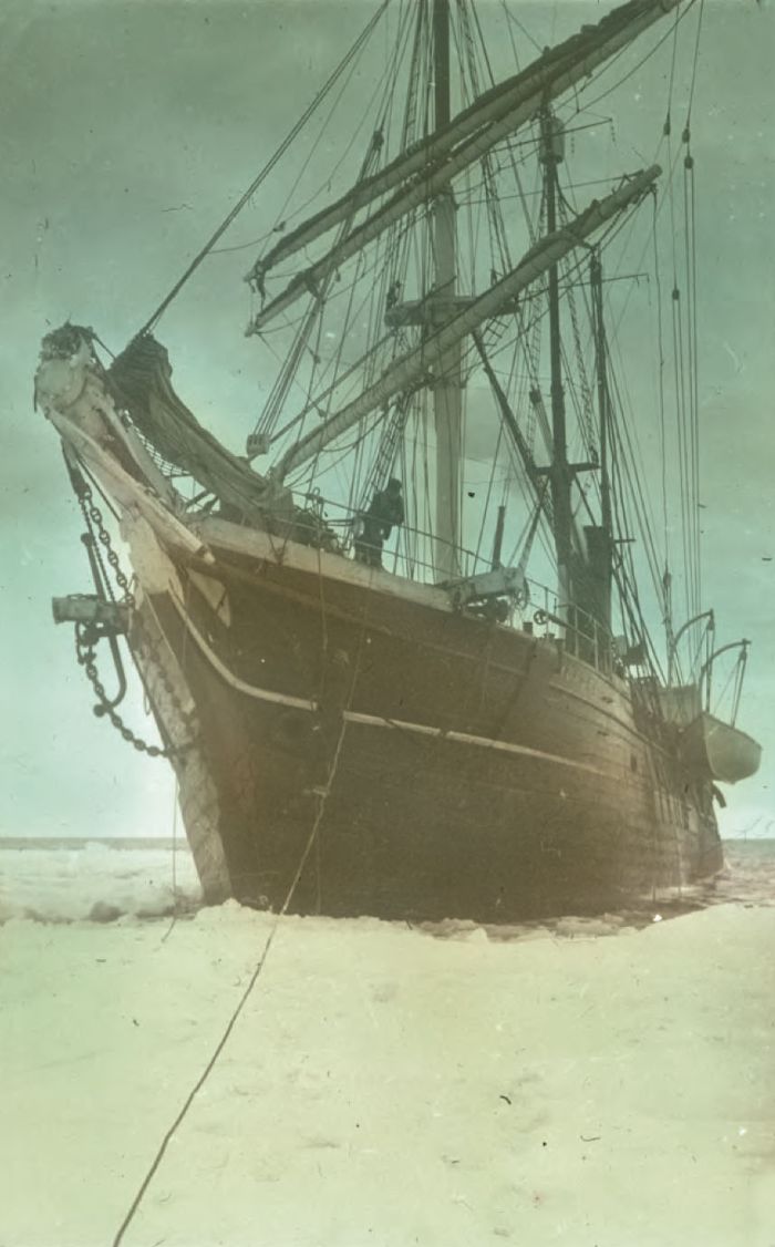 “Aurora” in McMurdo Sound waiting for break-up of the ice. Hand-coloured glass lantern slide, ca. 1914-ca. 1917. [Andrew] Keith Jack, compiler. H82.45/26. La Trobe Picture Collection. [hand-coloured photograph]